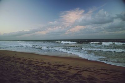 Scenic view of sea against cloudy sky