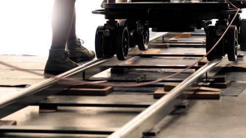 Low section of woman standing on railroad station