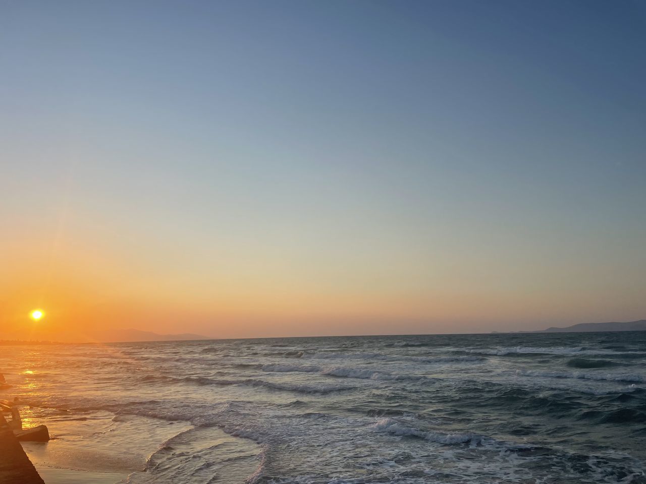 SCENIC VIEW OF SEA AGAINST ORANGE SKY