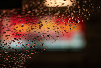 Close-up of wet glass window during rainy season