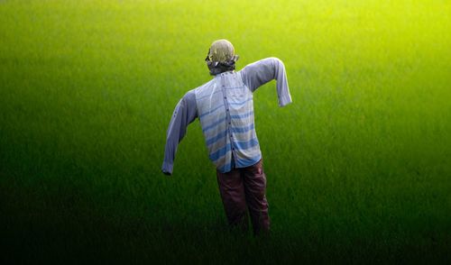 Rear view of person standing on field