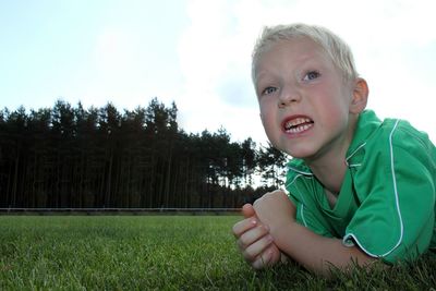 Boy lying down on field