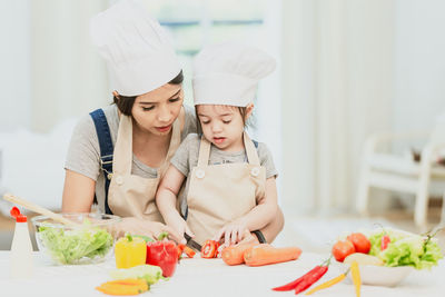 Midsection of woman having food in kitchen