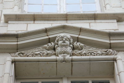 Low angle view of statue against building