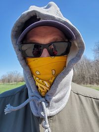 Portrait of person wearing sunglasses on field