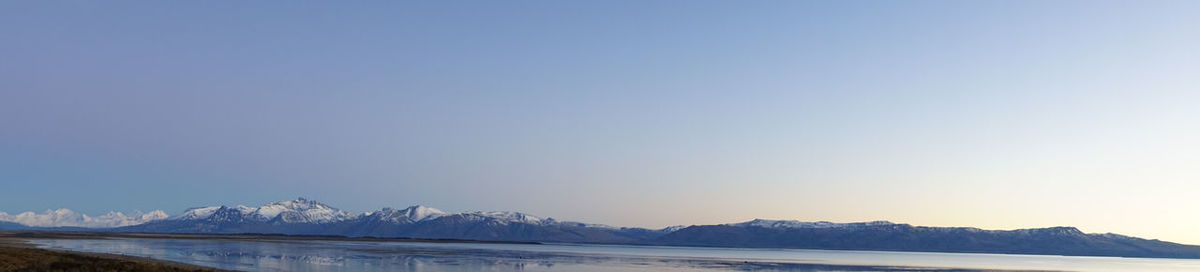 Scenic view of snowcapped mountains against clear sky