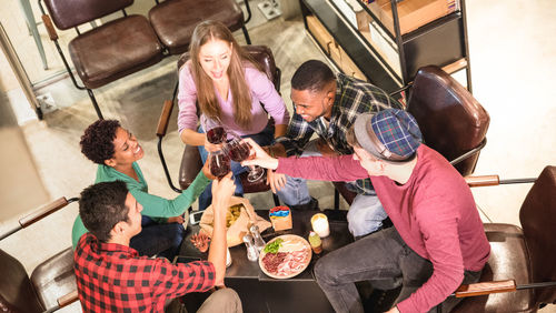 High angle view of friends having food at restaurant