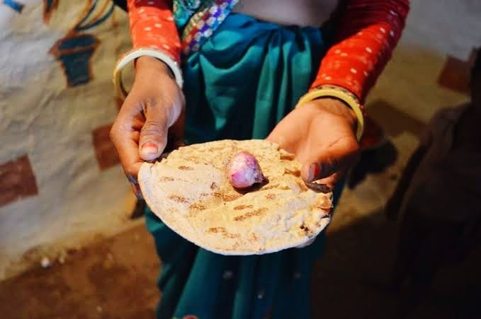 one person, adult, hand, midsection, women, holding, traditional clothing, bracelet, food, bangle, food and drink, focus on foreground, tradition, indian food, clothing, indoors, close-up