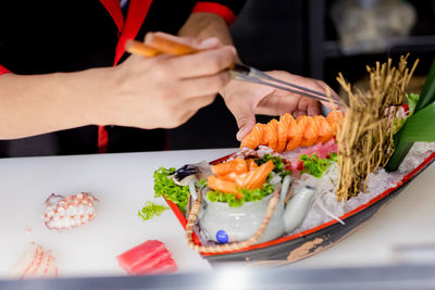 Midsection of chef preparing food on table