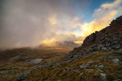 Scenic view of mountains against cloudy sky