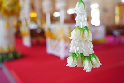 Close-up of figurine on illuminated table