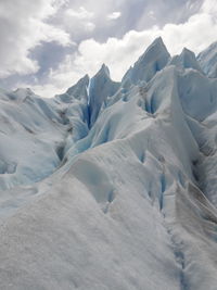 Scenic view of snow covered mountains against sky