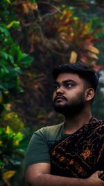 Portrait of young man looking away outdoors