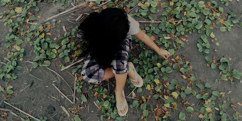 High angle view of woman sitting on ground