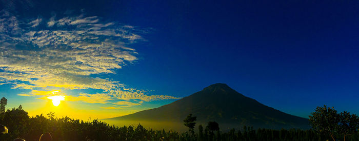 Scenic view of silhouette mountains against sky at sunset