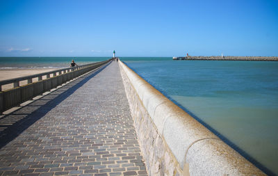 Scenic view of sea against clear blue sky