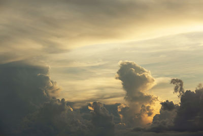 Beautiful sunset sky above clouds with dramatic light.