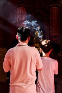 Rear view of couple at temple 