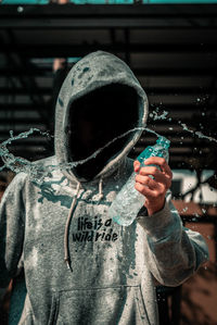 Full length of a man holding water