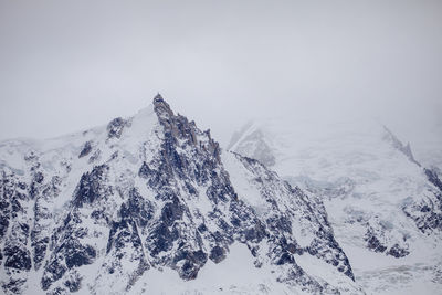 Scenic view of snowcapped mountains against clear sky