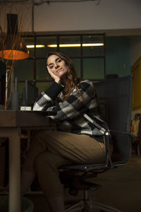 Portrait of smiling businesswoman sitting at office