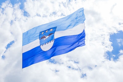 Low angle view of flag against cloudy sky