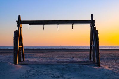 Scenic view of beach against sky during sunset