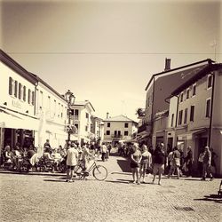 People on street in city against clear sky