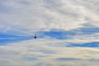 Low angle view of helicopter flying in sky