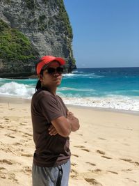 Full length of man wearing sunglasses standing on beach