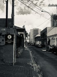 Street amidst buildings against sky in city