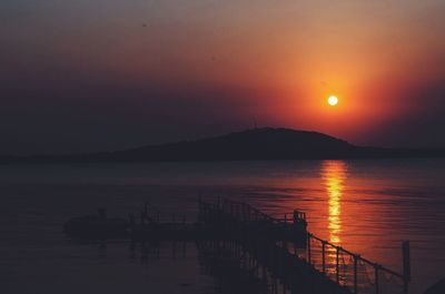 Scenic view of sea against orange sky