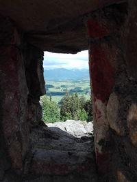 View of old building seen through window