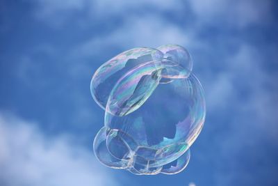 Low angle view of bubbles against sky