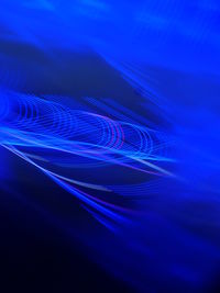 Close-up of light painting against blue background