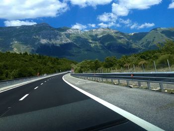 Empty road passing through landscape