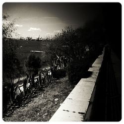 Railroad track against cloudy sky