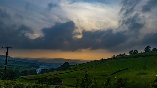 Scenic view of field against sky during sunset