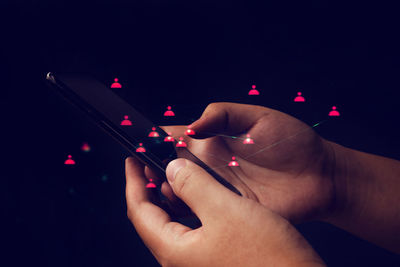 Close-up of hand holding illuminated lighting equipment