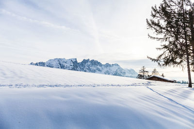 Snow covered landscape against sky