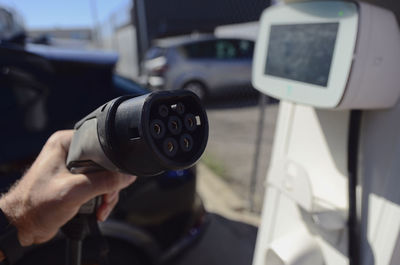 Close-up modern electric commercial van car plugged with fast charger at charging station. eco 