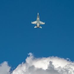 Low angle view of fighter plane flying in sky