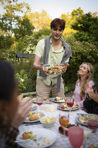 Portrait of smiling friends having food at restaurant