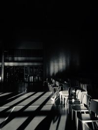 Empty chairs and tables in row