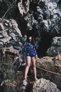 Full length of woman standing on rock