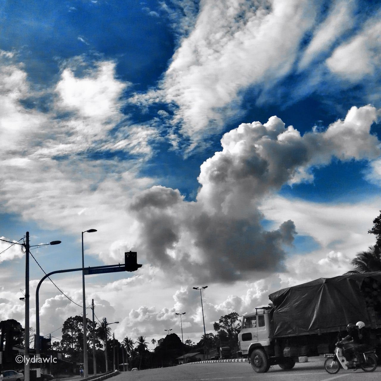 transportation, land vehicle, car, mode of transport, sky, road, cloud - sky, street light, street, cloudy, cloud, tree, parking, stationary, on the move, travel, outdoors, day, low angle view, parked