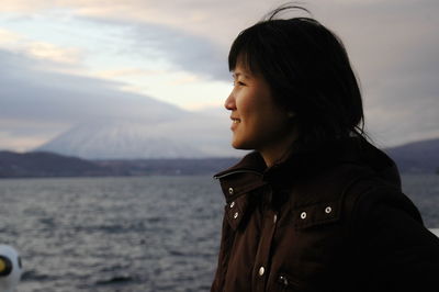 Close-up of woman standing against sky