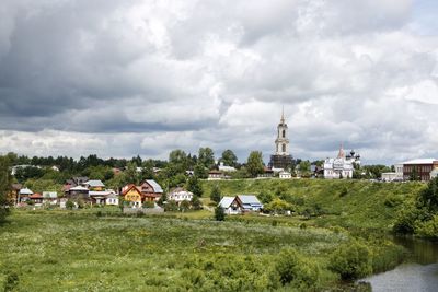 Panoramic view of trees and buildings against sky