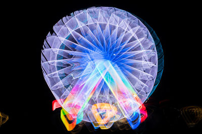 Close-up of illuminated lights against black background