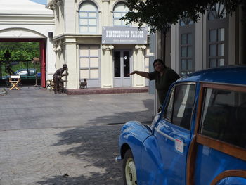 Man on street against buildings in city